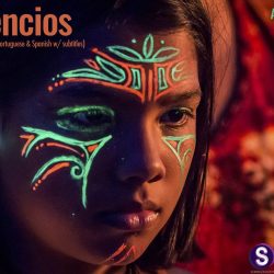 Film poster for Los Silencios - Image of an Indigenous person's face with green and red face paint