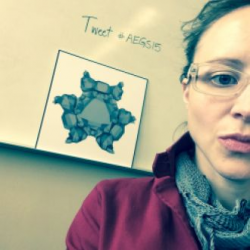 Selfie by Amanda Starling Gould w/ half face visible, white board in background with computer-generated abstract image