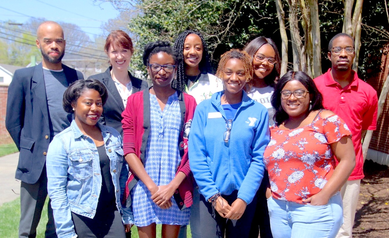 Outdoors group shot of NCCU student contributors (8) with Prof. Julie Nelson